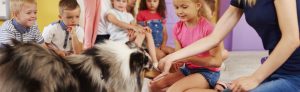 kids gathered around dog